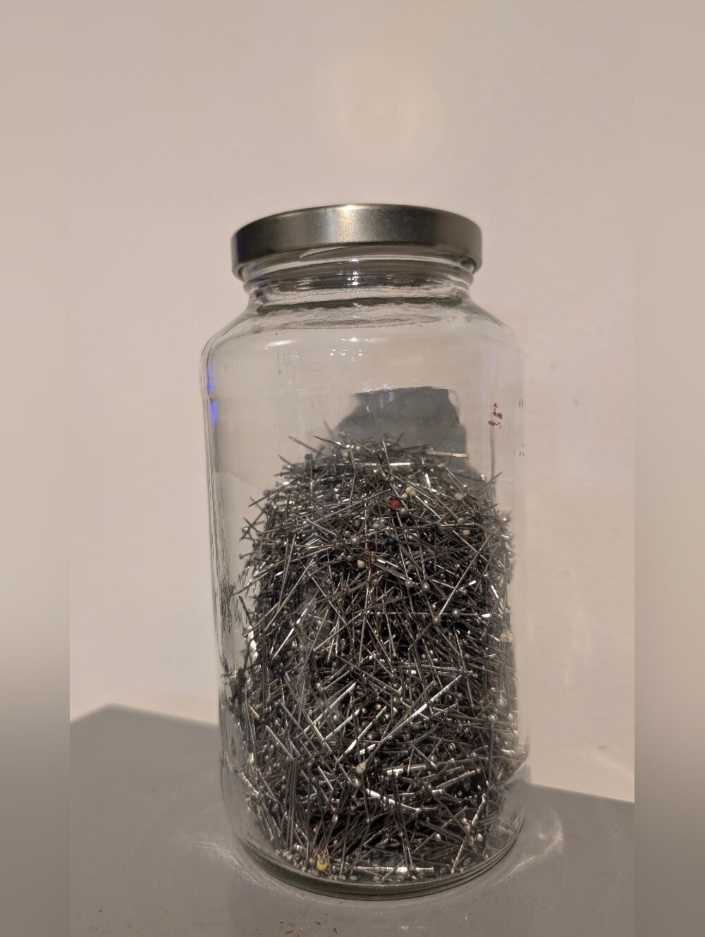 Glass Jar of Silver Sewing Pins